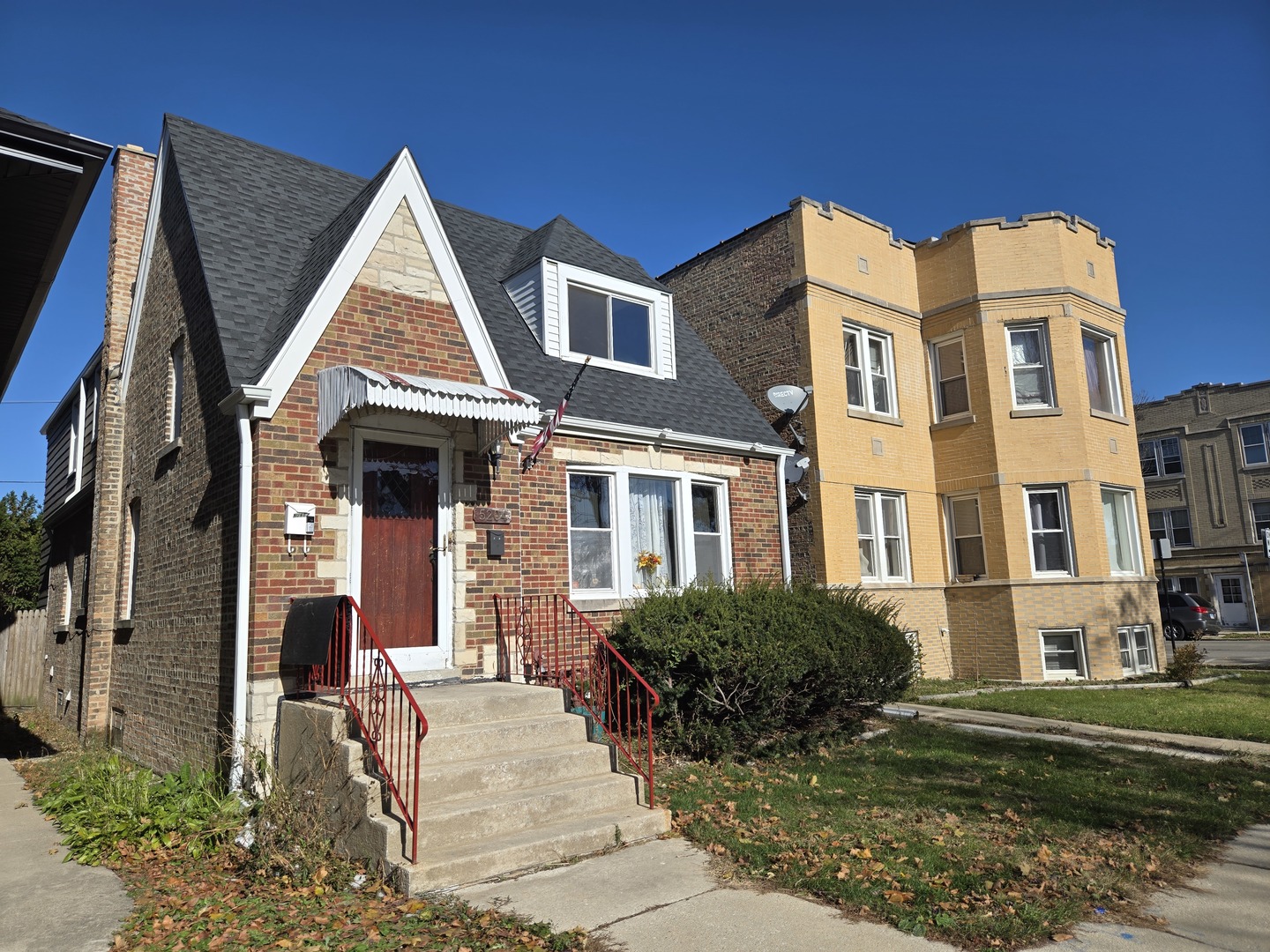 5204 West Newport Avenue, Unit 2 Chicago, IL 60641 - Photo 1 of 10 a view of a brick house with many windows and yard