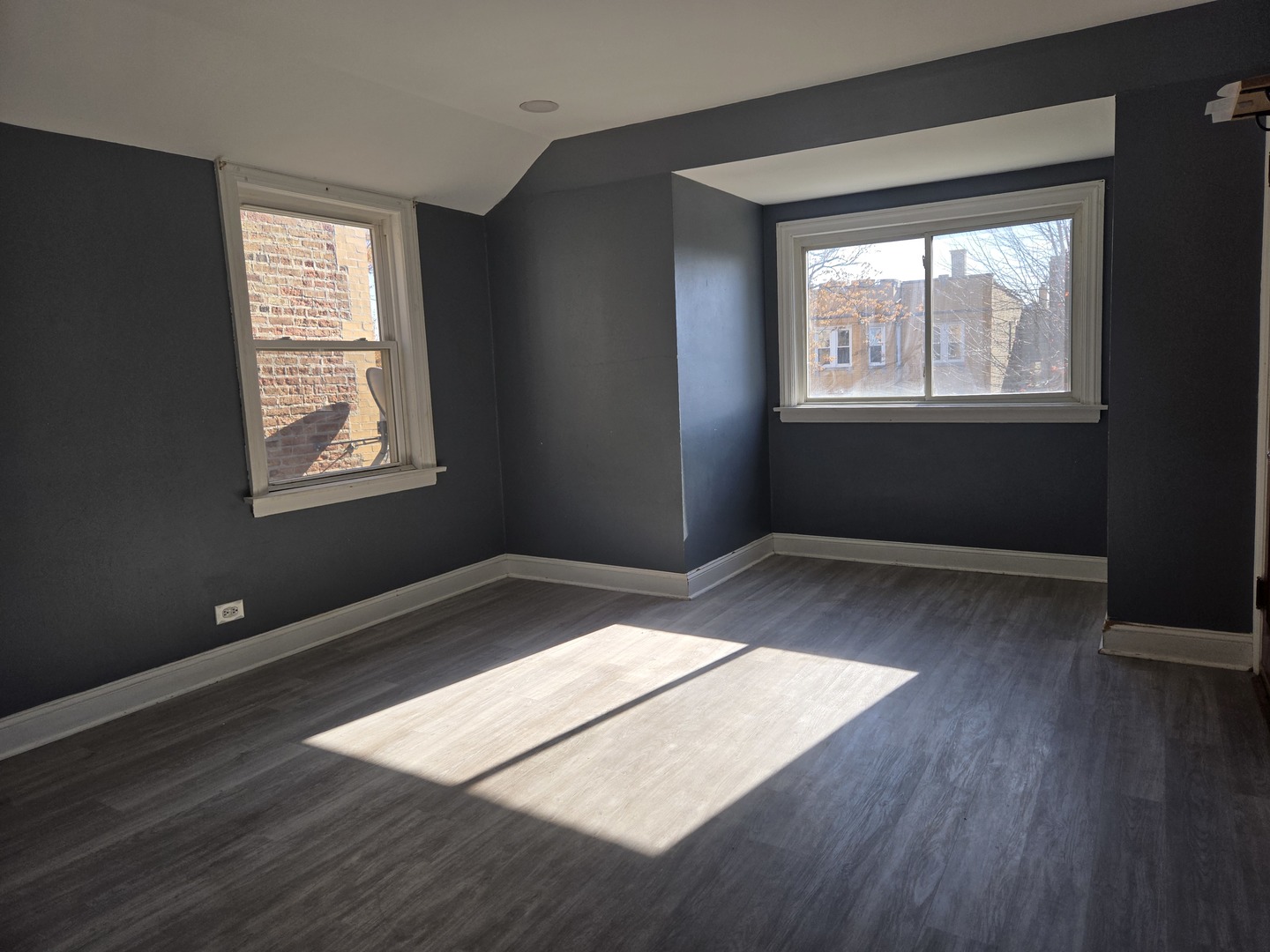 5204 West Newport Avenue, Unit 2 Chicago, IL 60641 - Photo 2 of 10 a view of an empty room and wooden floor and window