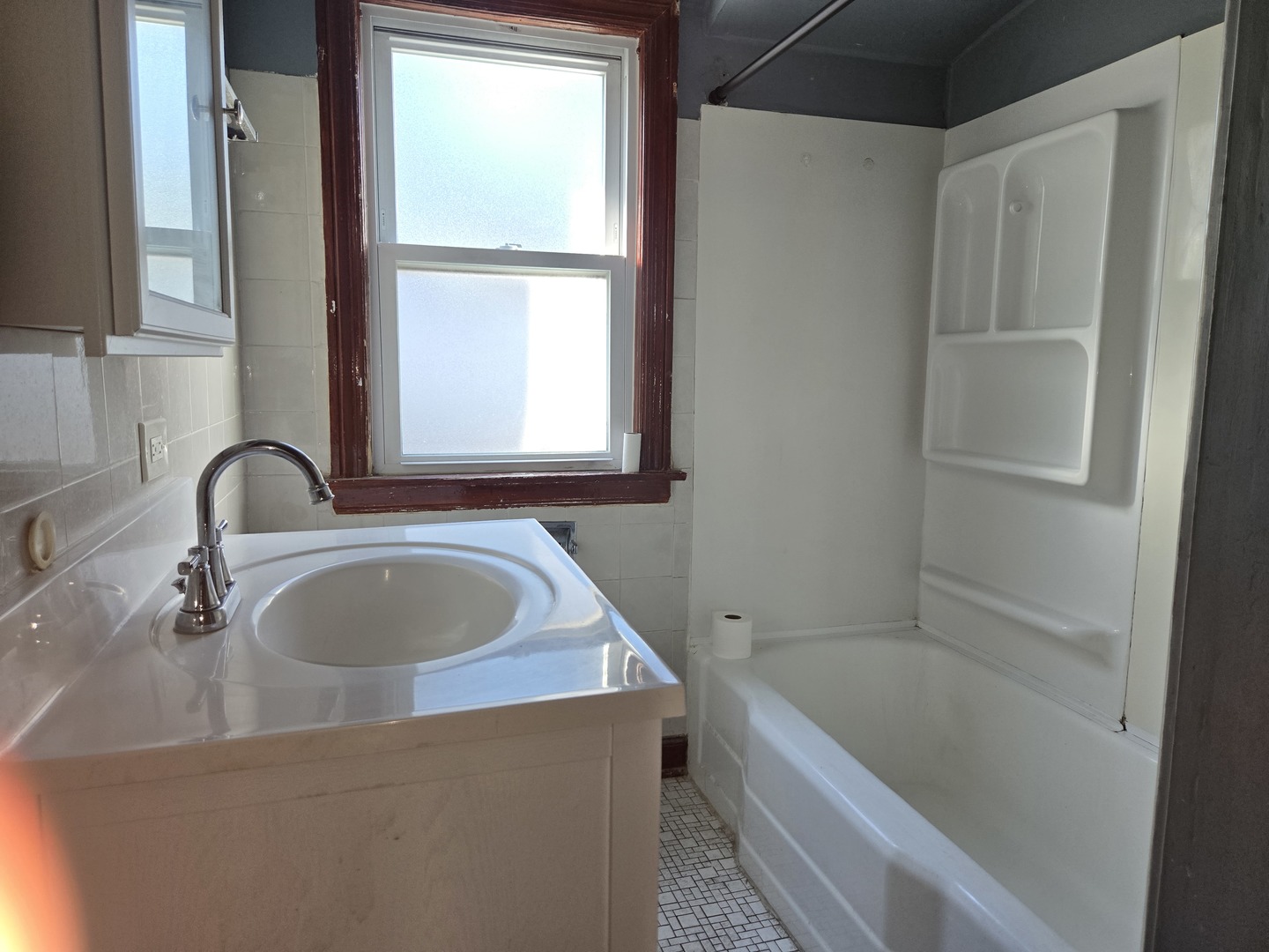 5204 West Newport Avenue, Unit 2 Chicago, IL 60641 - Photo 8 of 10 a bathroom with a tub sink and mirror