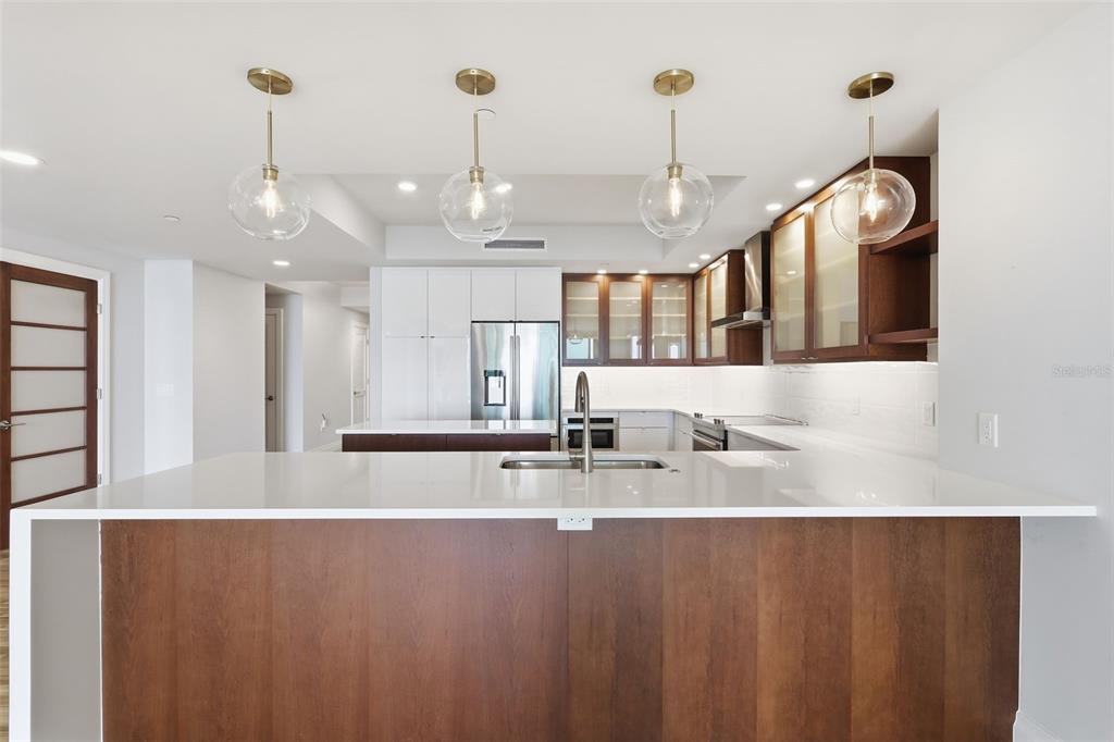 800 Collany Road, Unit 302 St. Petersburg, FL 33715 - Photo 14 of 66 a view of a kitchen with stainless steel appliances granite countertop cabinets and a chandelier