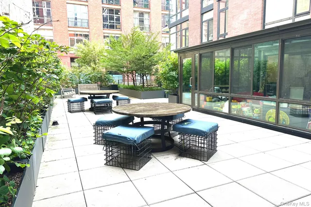 a building outdoor space with patio furniture and potted plants