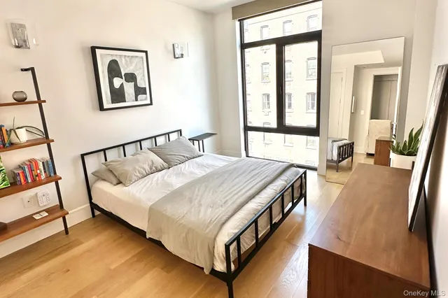 a bedroom with a bed and painting on the wall