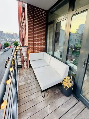 a balcony with furniture and a potted plant