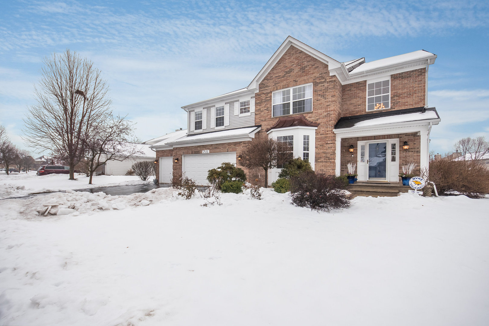 712 Eagle Brook Lane Naperville, IL 60565 - Photo 2 of 40 a front view of a house with a yard covered in snow