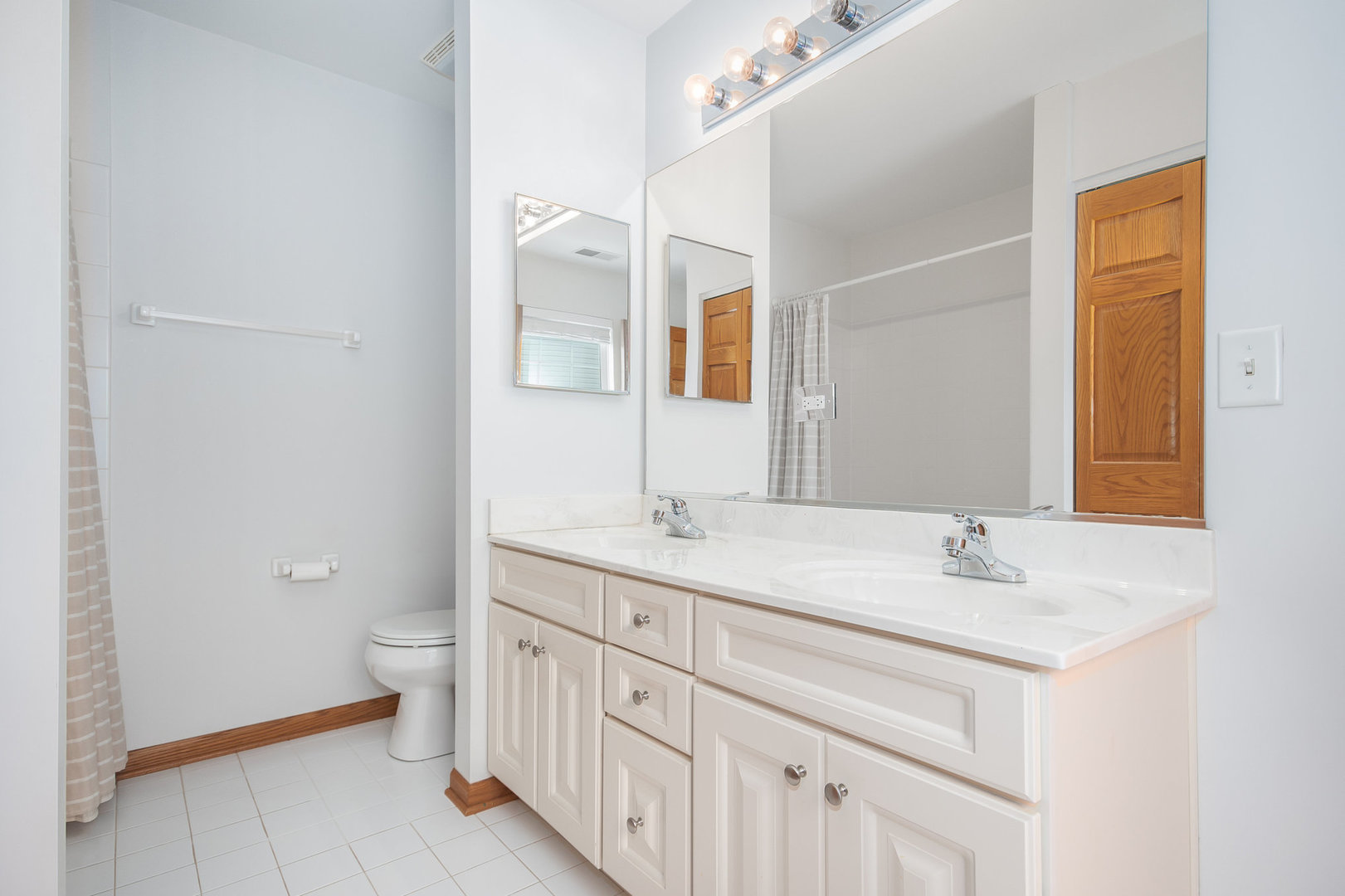 712 Eagle Brook Lane Naperville, IL 60565 - Photo 27 of 40 a bathroom with a granite countertop sink and a mirror