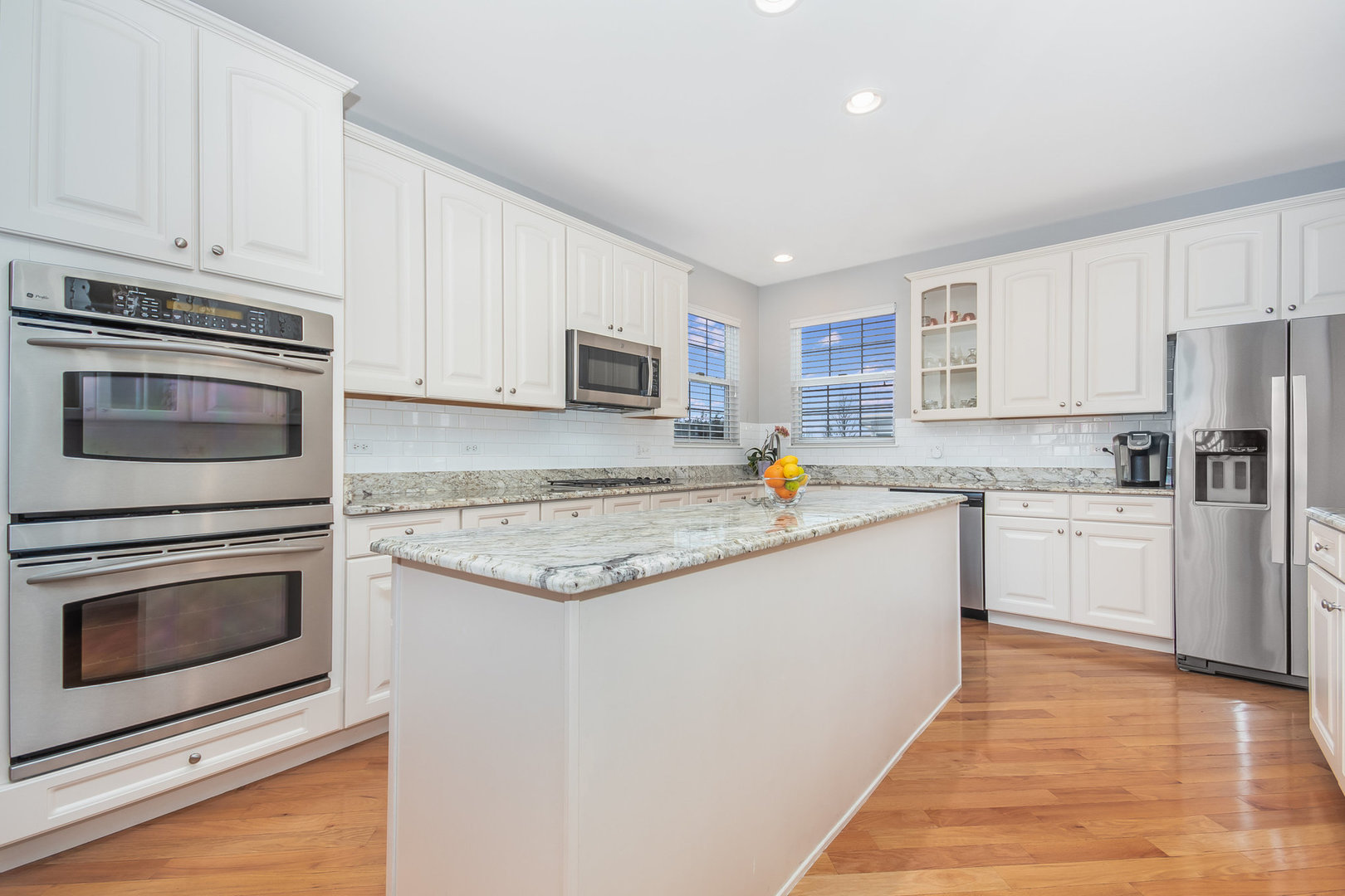 712 Eagle Brook Lane Naperville, IL 60565 - Photo 3 of 40 a kitchen with granite countertop white cabinets and stainless steel appliances