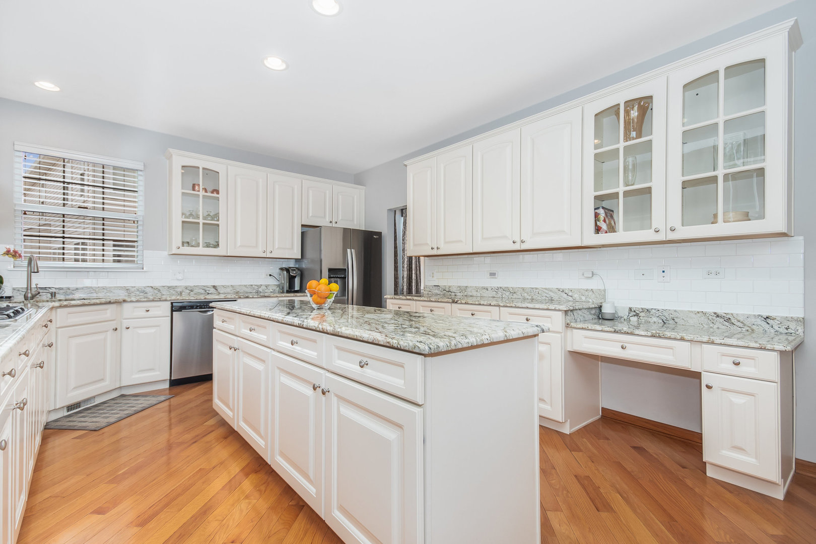 712 Eagle Brook Lane Naperville, IL 60565 - Photo 4 of 40 a kitchen with stainless steel appliances granite countertop a sink stove cabinets and wooden floor