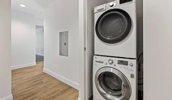 a view of a hallway with washer and dryer