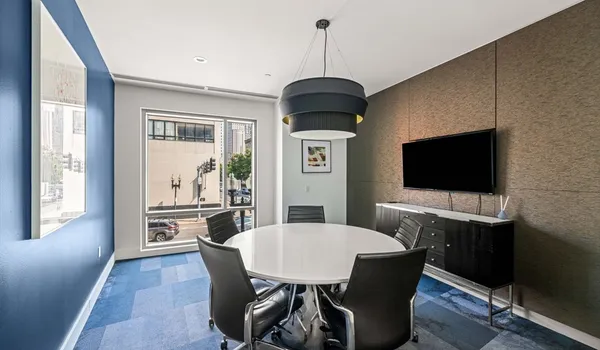 a dining room with furniture window and wooden floor