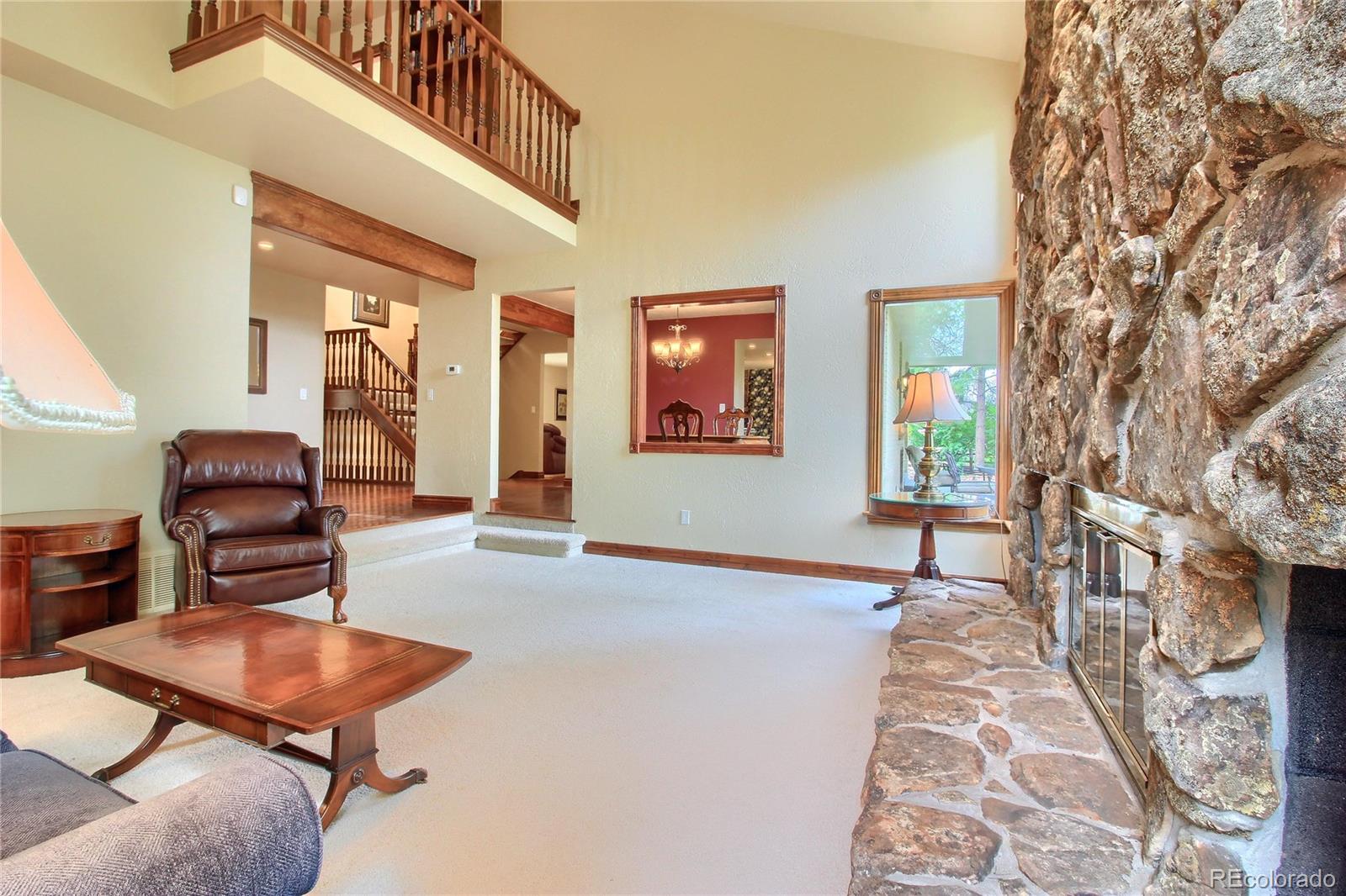 5661 West Lakeridge Road Lakewood, CO 80227 - Photo 11 of 35 a living room with furniture and a wooden floor