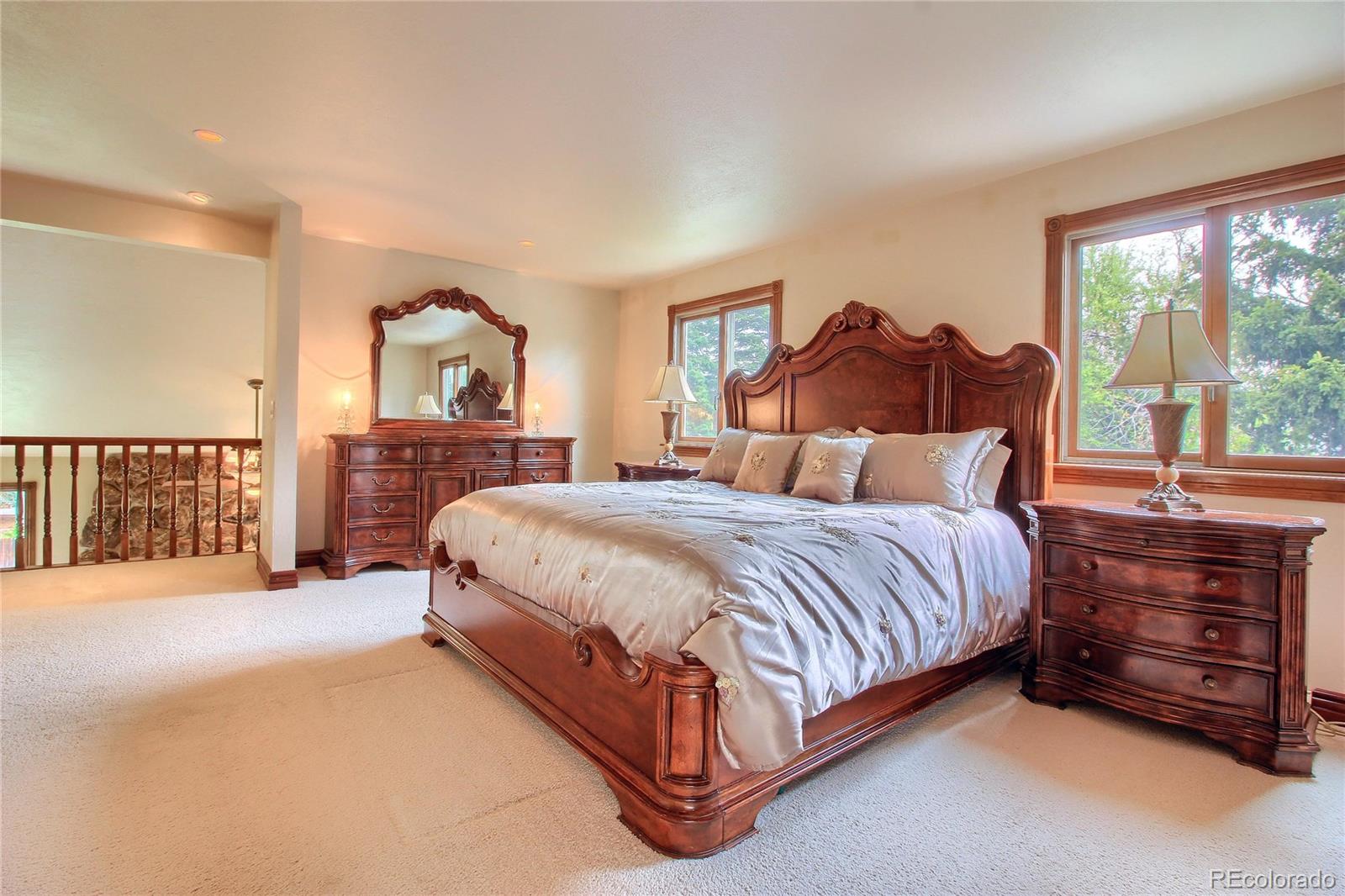5661 West Lakeridge Road Lakewood, CO 80227 - Photo 17 of 35 a bedroom with a bed and a dresser next to a window