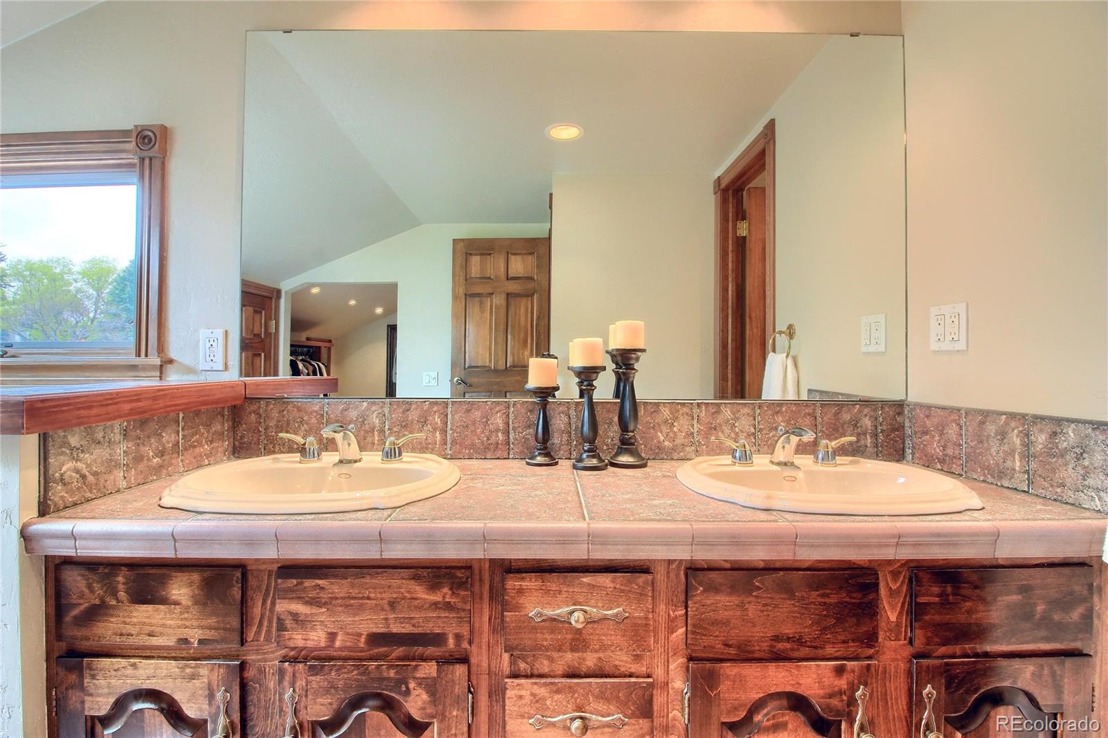 5661 West Lakeridge Road Lakewood, CO 80227 - Photo 18 of 35 a bathroom with a granite countertop sink and a mirror
