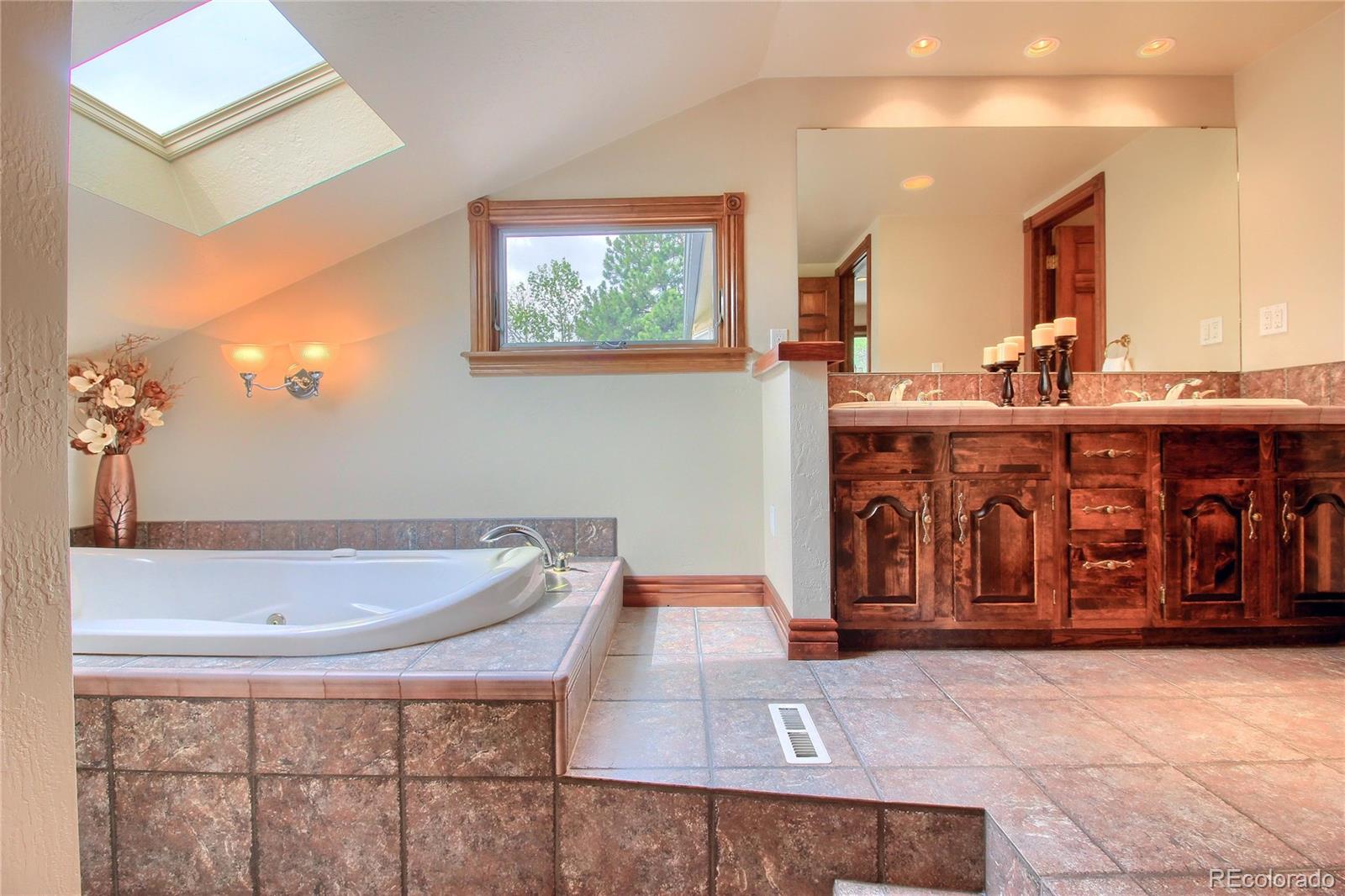 5661 West Lakeridge Road Lakewood, CO 80227 - Photo 21 of 35 a bathroom with a tub and sink