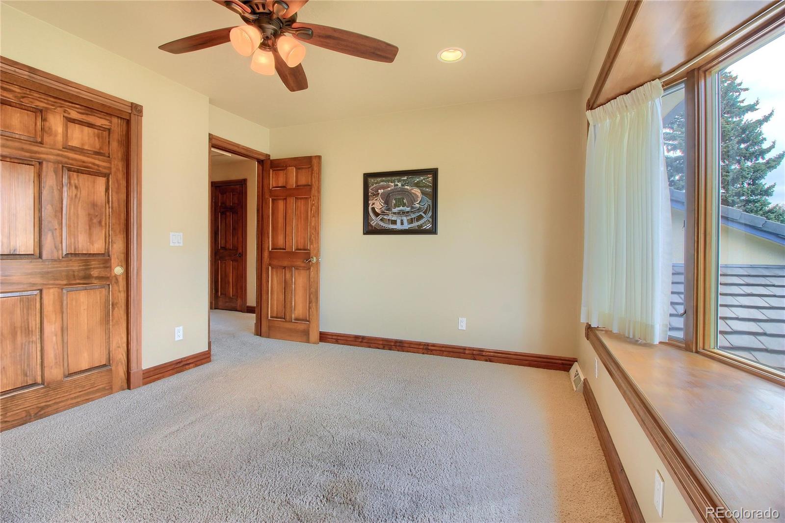 5661 West Lakeridge Road Lakewood, CO 80227 - Photo 23 of 35 an empty room with windows and fan