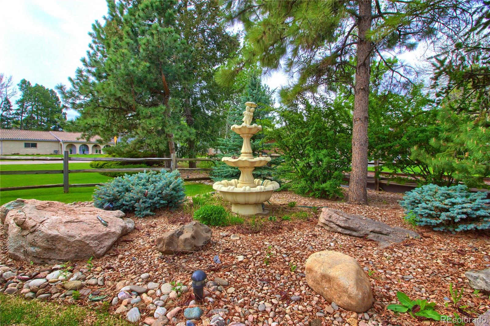 5661 West Lakeridge Road Lakewood, CO 80227 - Photo 32 of 35 a view of a garden with plants and large trees
