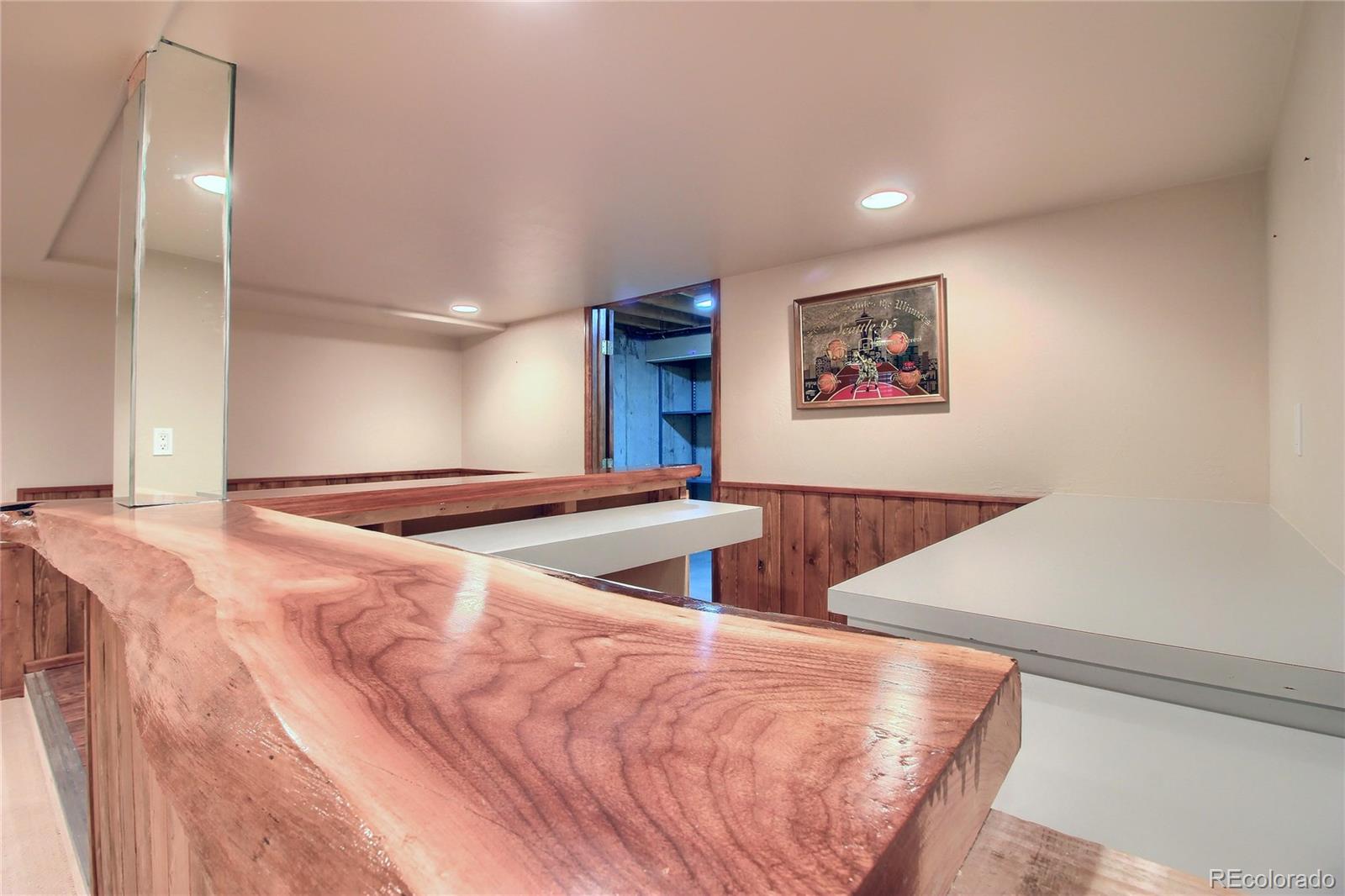 5661 West Lakeridge Road Lakewood, CO 80227 - Photo 34 of 35 a view of an empty room with wooden floor
