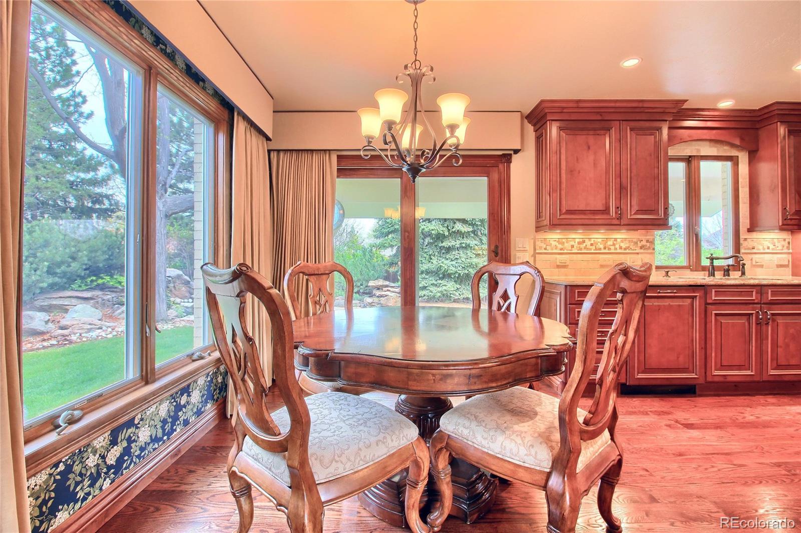 5661 West Lakeridge Road Lakewood, CO 80227 - Photo 4 of 35 a dining room with furniture water view and a floor to ceiling window