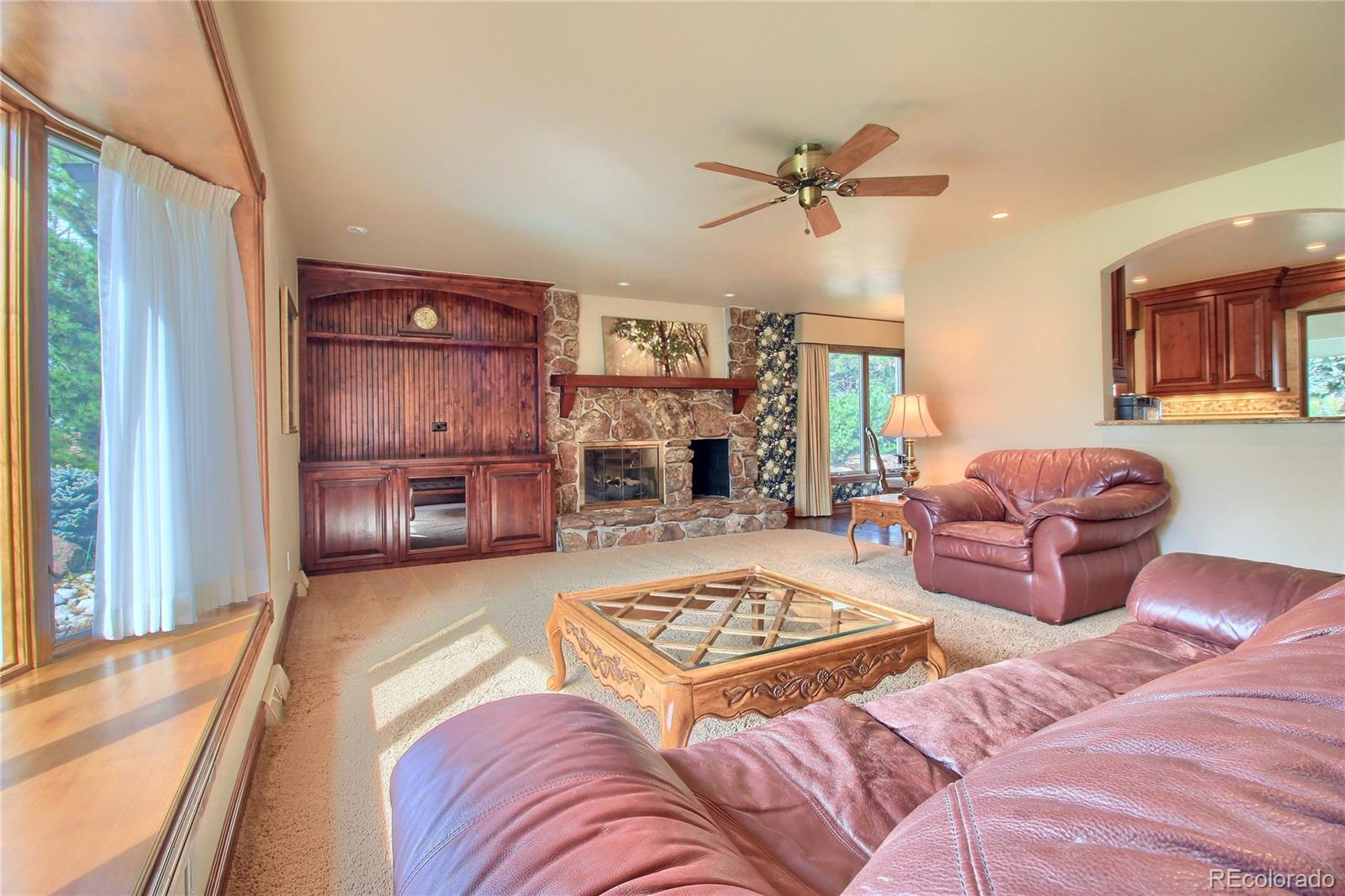 5661 West Lakeridge Road Lakewood, CO 80227 - Photo 5 of 35 a living room with furniture and a fireplace