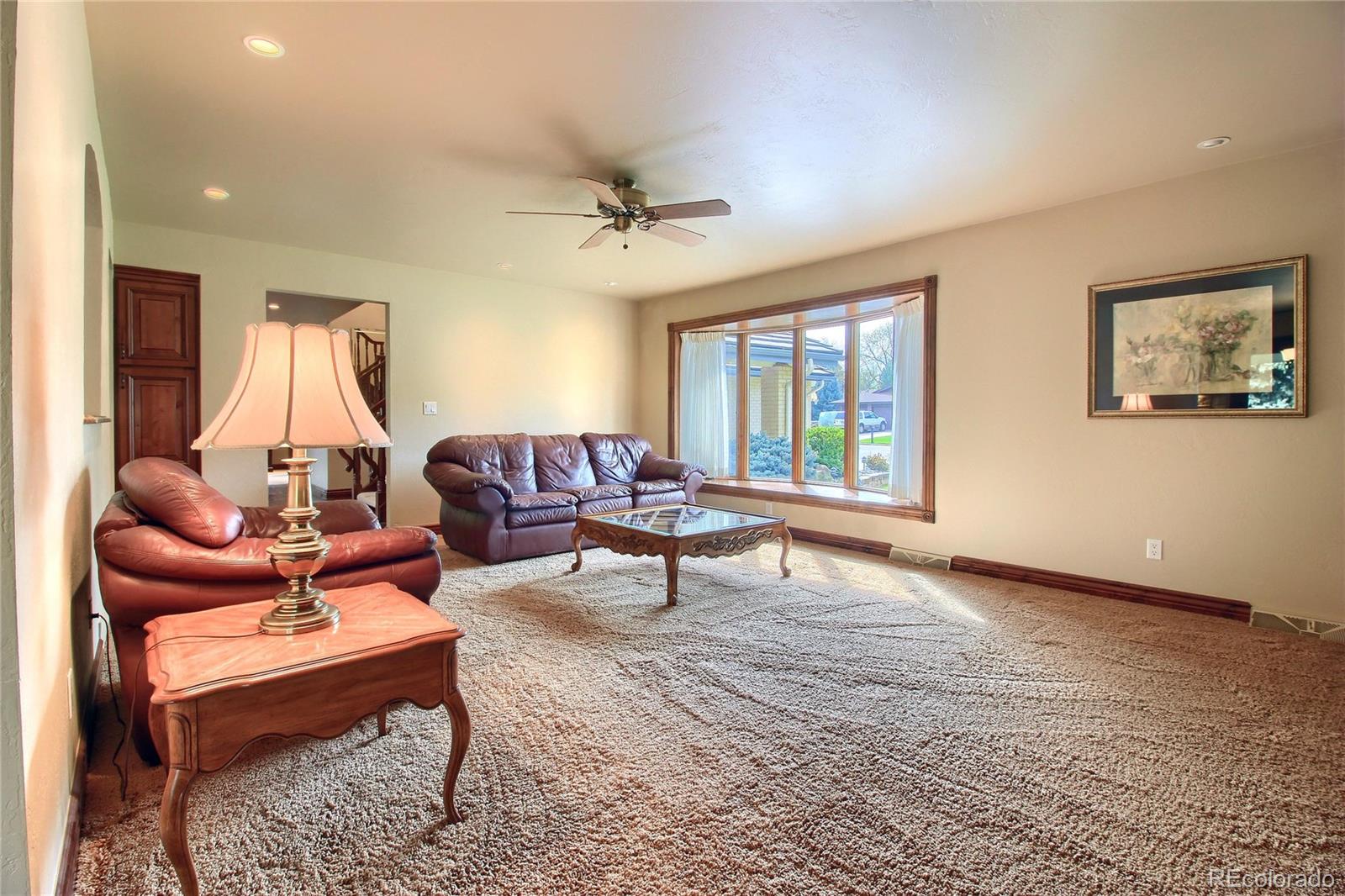 5661 West Lakeridge Road Lakewood, CO 80227 - Photo 6 of 35 a living room with furniture a window and a flat screen tv