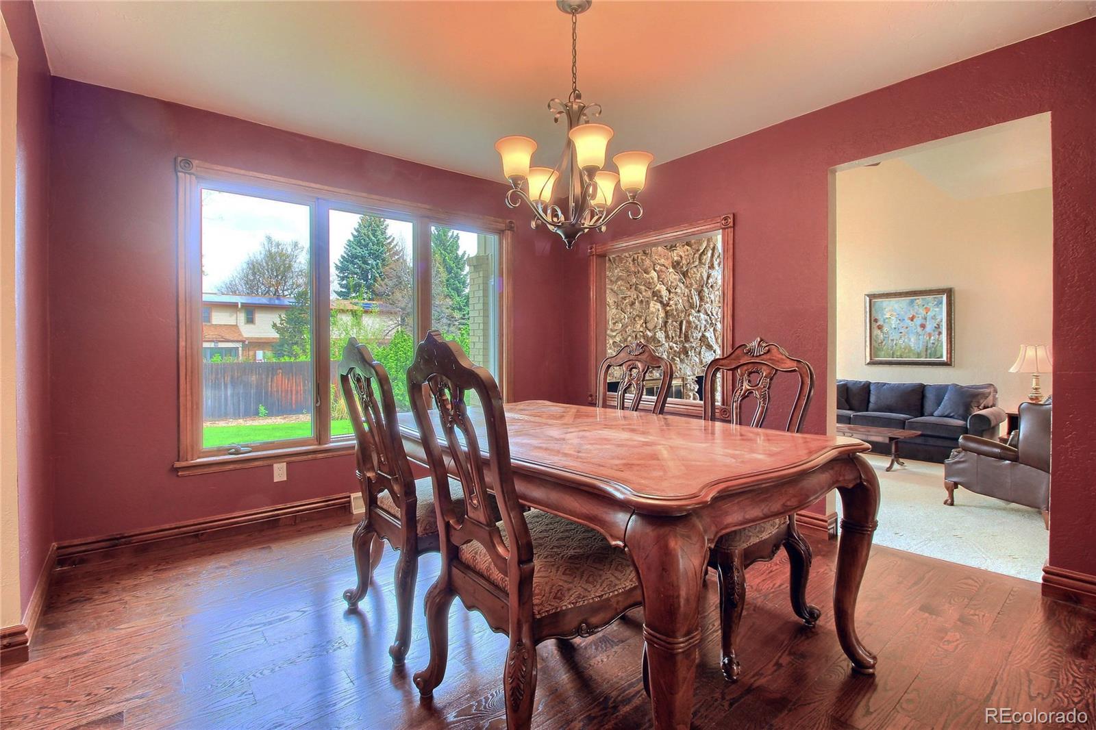 5661 West Lakeridge Road Lakewood, CO 80227 - Photo 8 of 35 a view of a dining room with furniture window and wooden floor