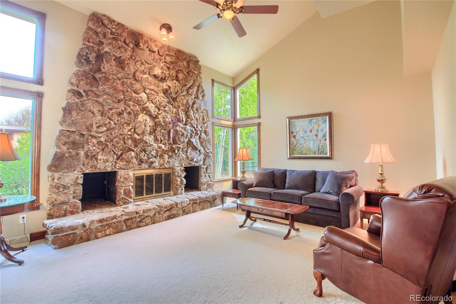 5661 West Lakeridge Road Lakewood, CO 80227 - Photo 9 of 35 a living room with furniture and a fireplace