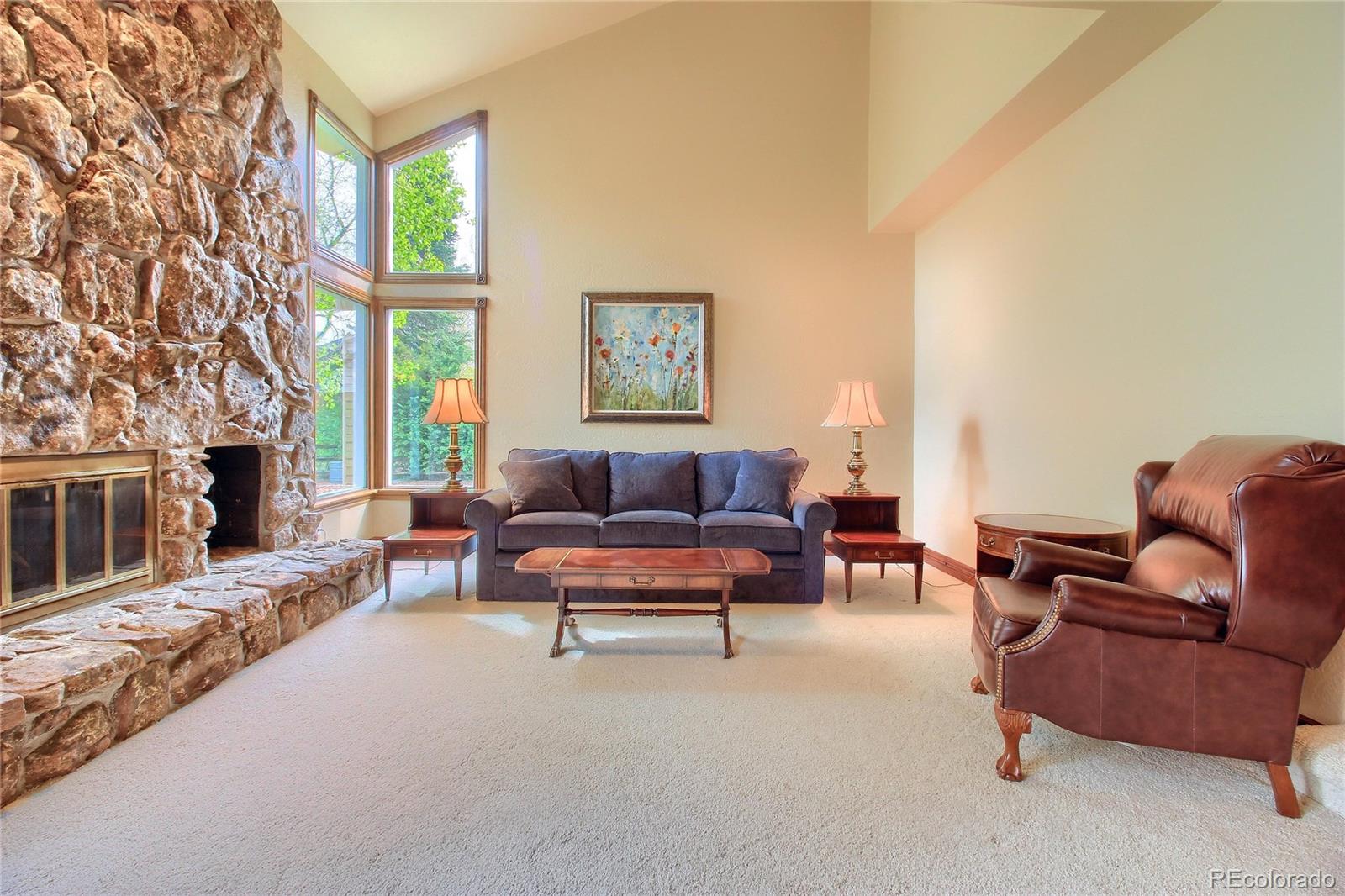 5661 West Lakeridge Road Lakewood, CO 80227 - Photo 10 of 35 a living room with furniture and a fireplace
