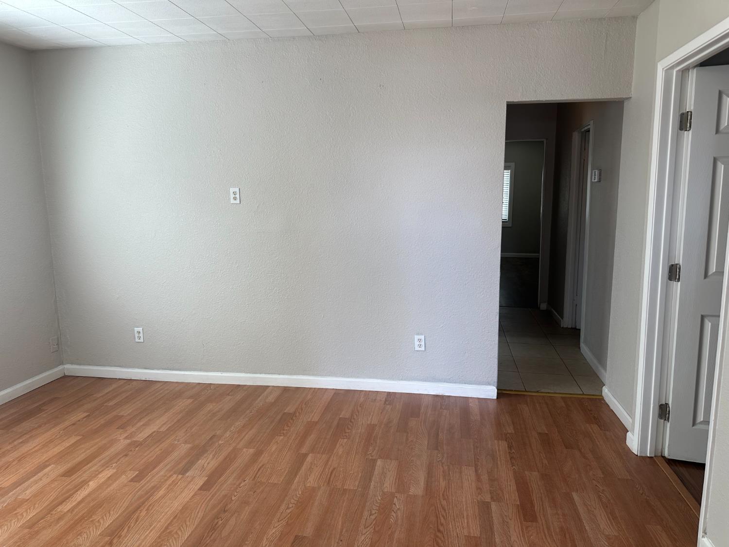 1235 N Street Newman, CA 95360 - Photo 20 of 33 a view of an empty room with wooden floor