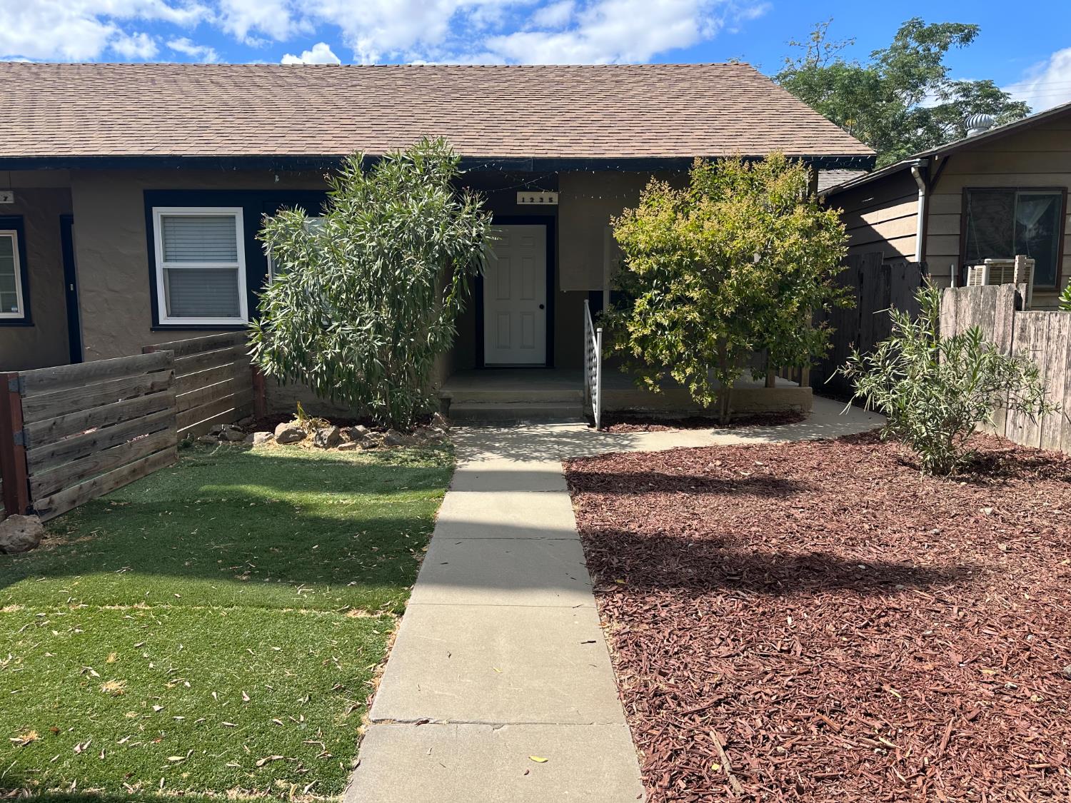 1235 N Street Newman, CA 95360 - Photo 2 of 33 a front view of a house with a garden