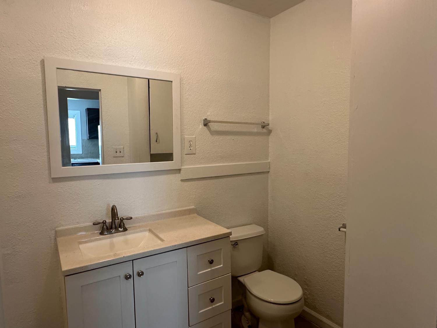 1235 N Street Newman, CA 95360 - Photo 27 of 33 a bathroom with a toilet a sink and mirror