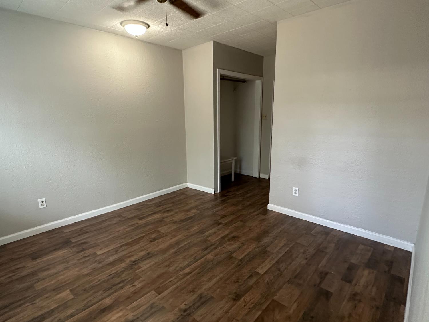 1235 N Street Newman, CA 95360 - Photo 31 of 33 a view of an empty room with wooden floor and a window