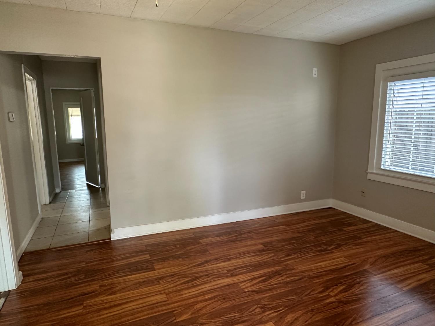 1235 N Street Newman, CA 95360 - Photo 4 of 33 a view of a room with wooden floor and window
