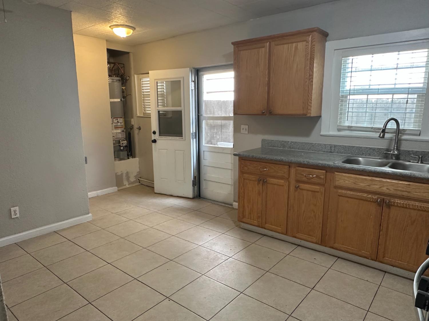 1235 N Street Newman, CA 95360 - Photo 7 of 33 a kitchen with a sink and cabinets