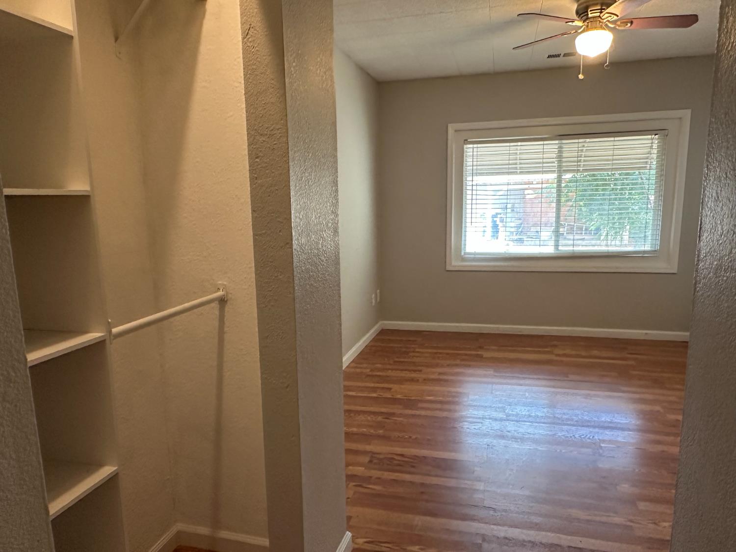 1235 N Street Newman, CA 95360 - Photo 10 of 33 a view of an empty room with wooden floor and a window