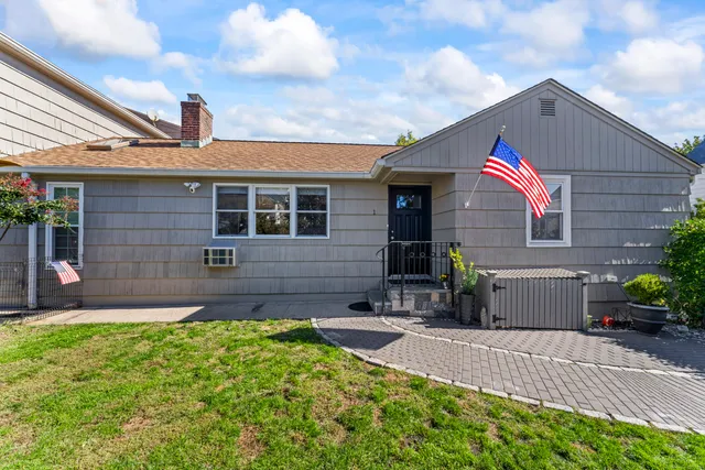a front view of a house with a yard