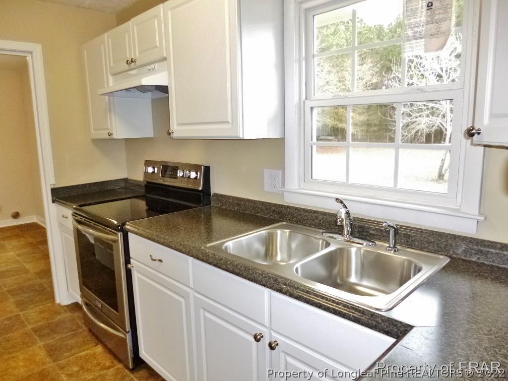 5135 Murphy Road Stedman, NC 28391 - Photo 11 of 33 a kitchen that has a sink and a granite counter tops with a window
