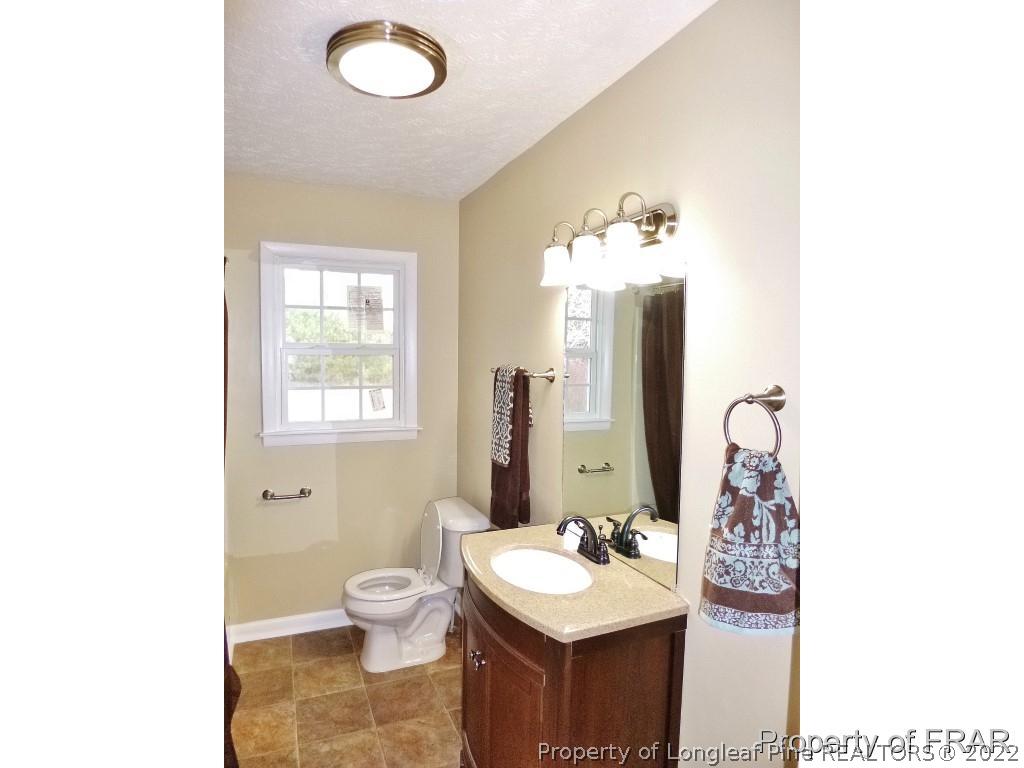 5135 Murphy Road Stedman, NC 28391 - Photo 23 of 33 a bathroom with a toilet sink and mirror