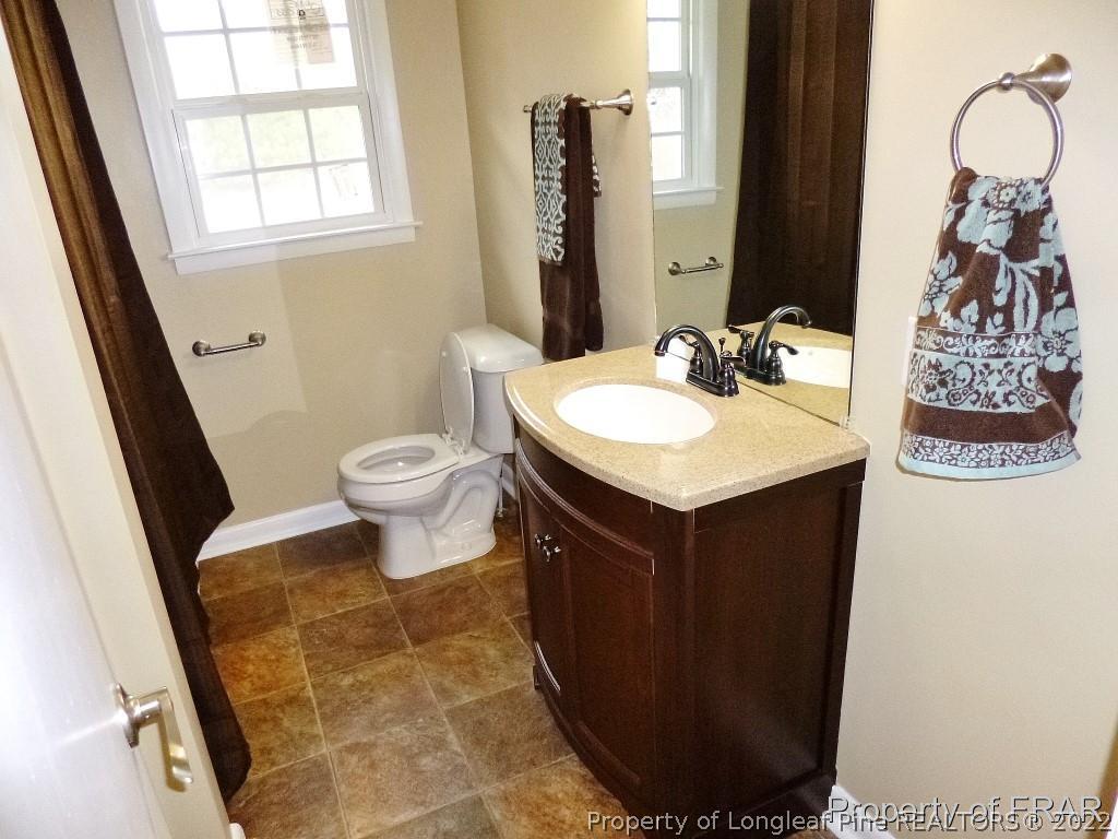 5135 Murphy Road Stedman, NC 28391 - Photo 24 of 33 a bathroom with a sink and a mirror