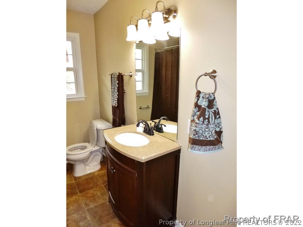 5135 Murphy Road Stedman, NC 28391 - Photo 25 of 33 a bathroom with a sink and a mirror