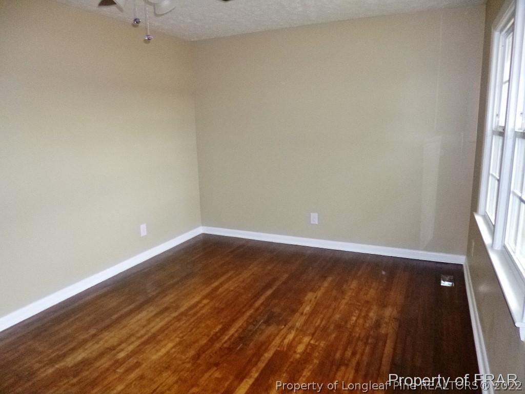 5135 Murphy Road Stedman, NC 28391 - Photo 5 of 33 an empty room with wooden floor and windows