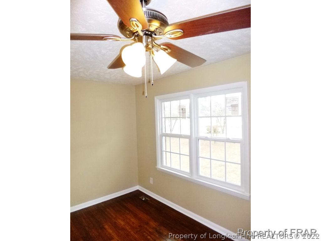 5135 Murphy Road Stedman, NC 28391 - Photo 6 of 33 a view of an empty room with window and wooden floor