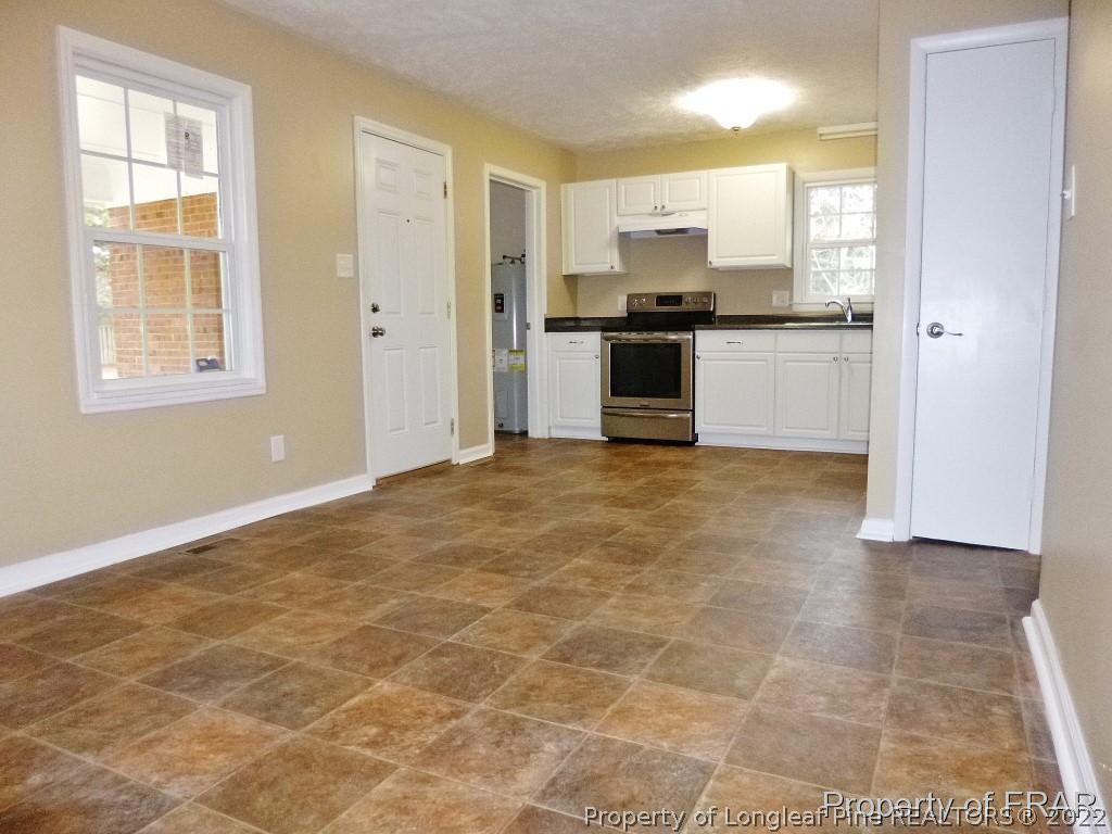 5135 Murphy Road Stedman, NC 28391 - Photo 9 of 33 a view of a kitchen with a stove cabinets and a kitchen