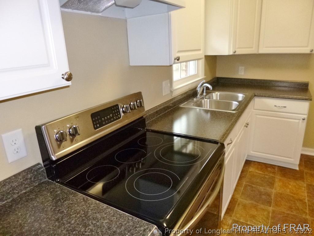 5135 Murphy Road Stedman, NC 28391 - Photo 10 of 33 a kitchen with a stove and a sink