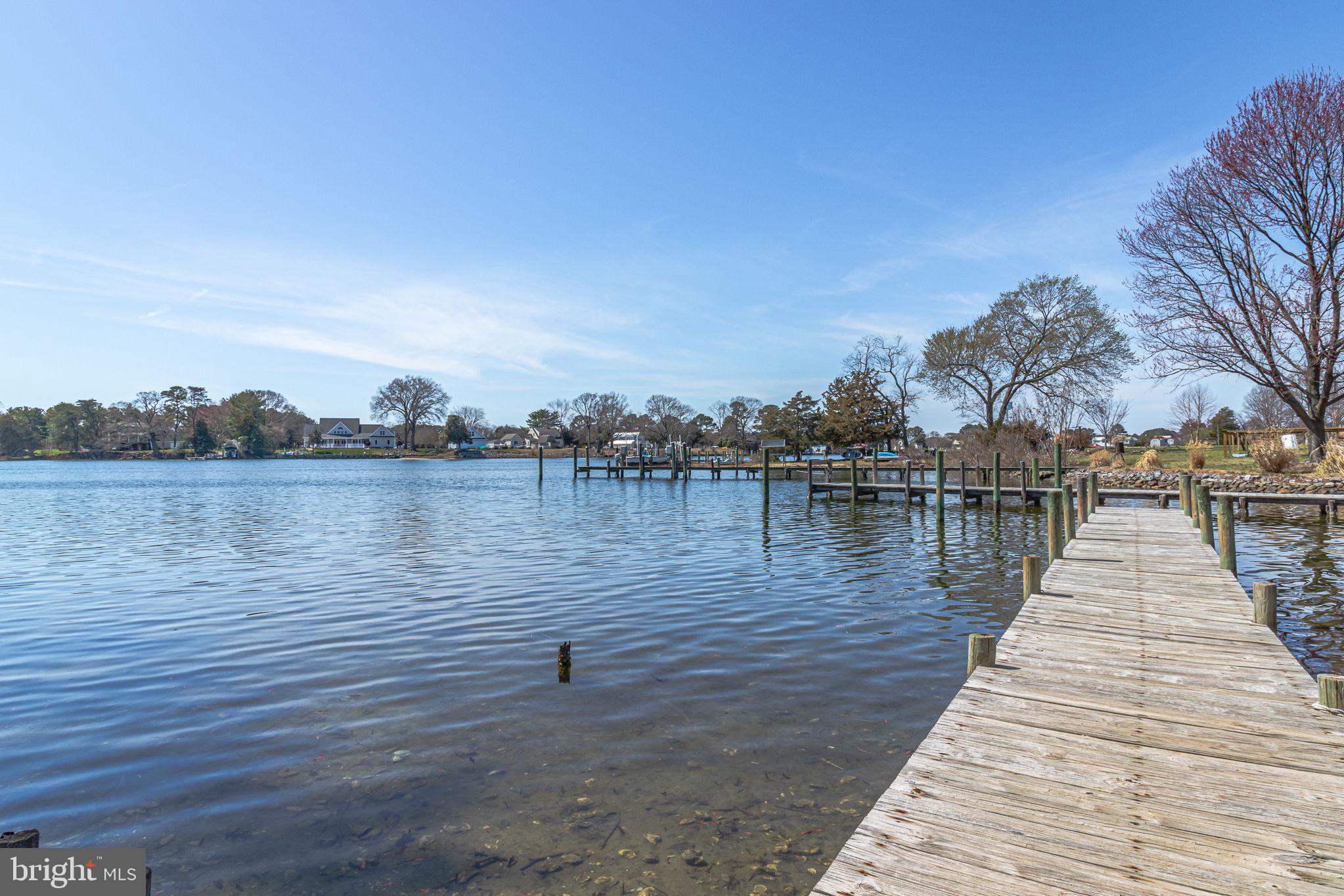 305 Colieville Lane Reedville, VA 22539 - Photo 3 of 49 Serene waterfront with a wooden dock.