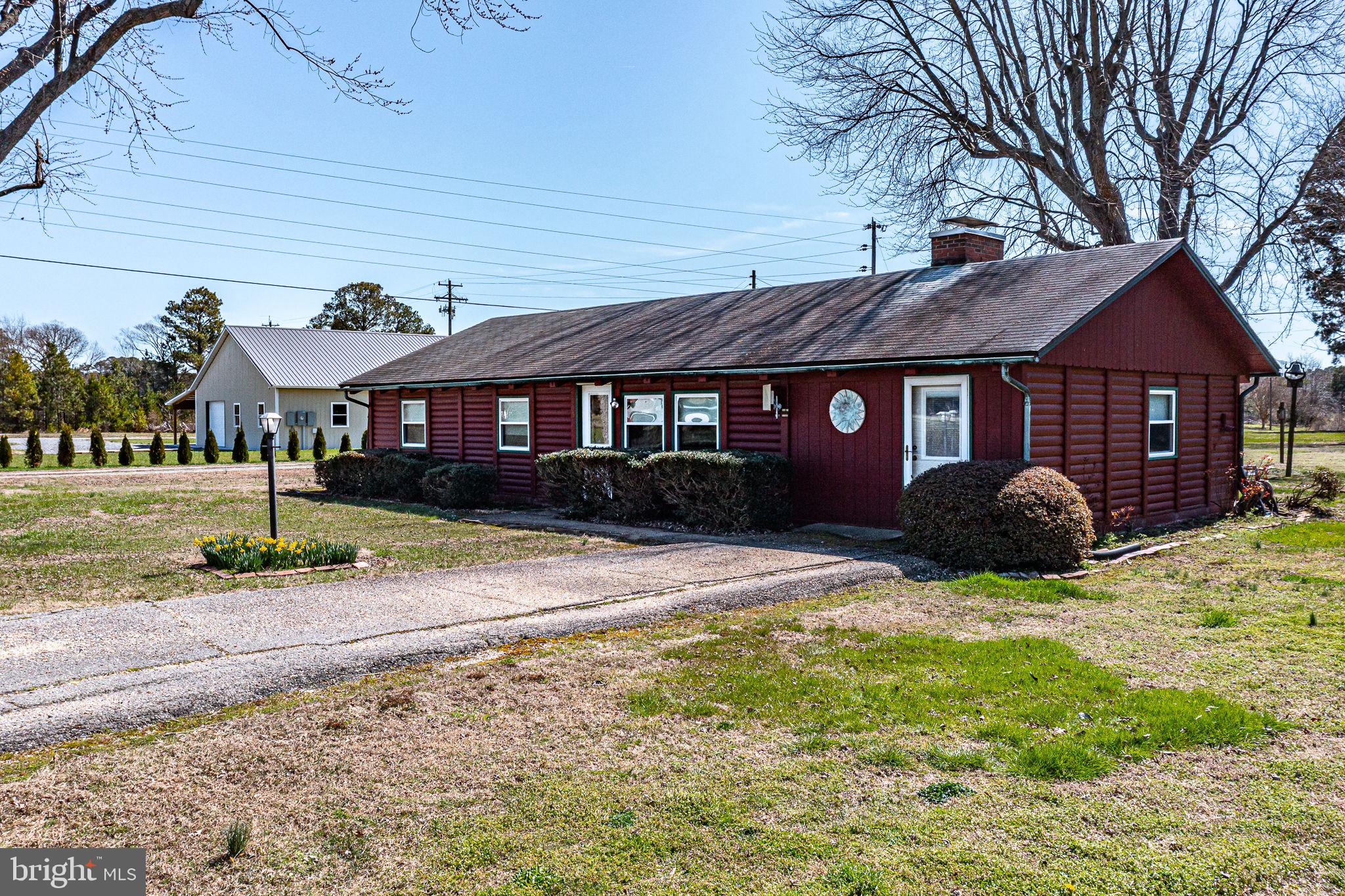 305 Colieville Lane Reedville, VA 22539 - Photo 33 of 49 Charming red cottage with lush greenery.