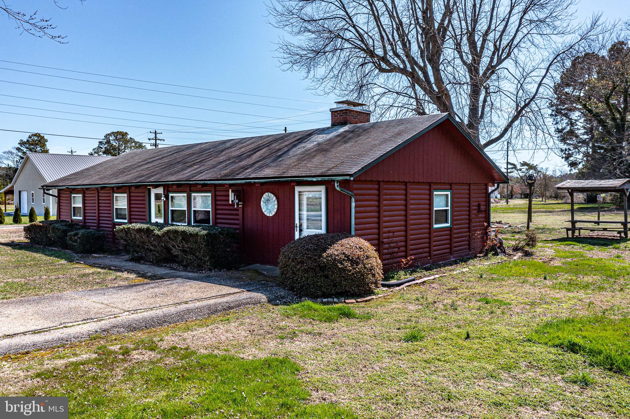305 Colieville Lane Reedville, VA 22539 - Photo 36 of 49 Charming red cottage with lush greenery.