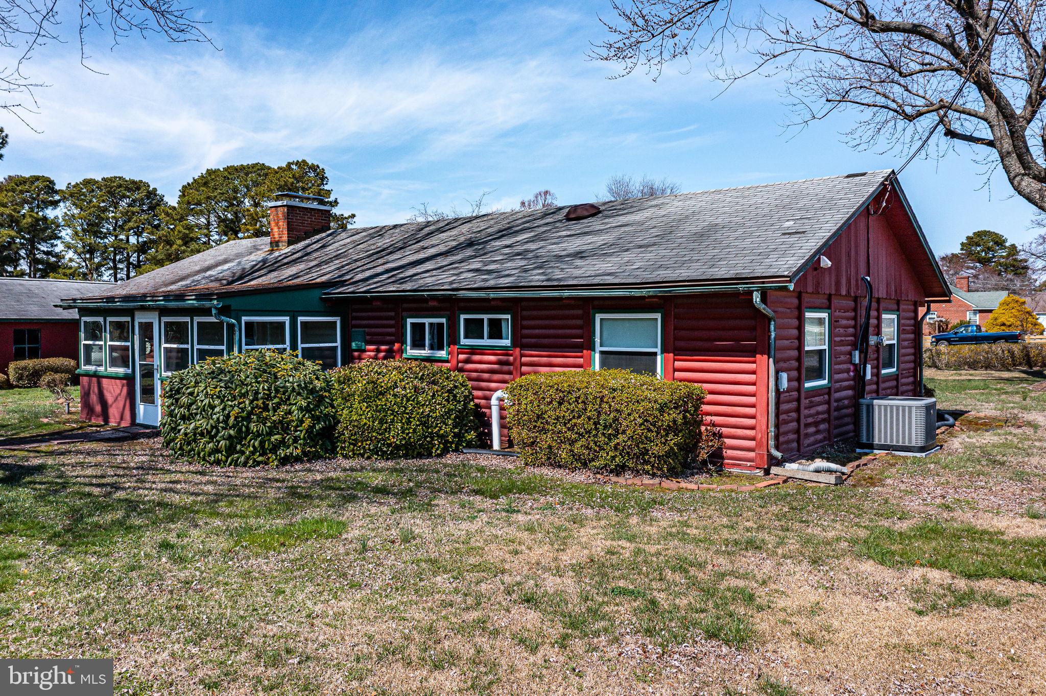 305 Colieville Lane Reedville, VA 22539 - Photo 39 of 49 Charming red cottage with lush greenery.