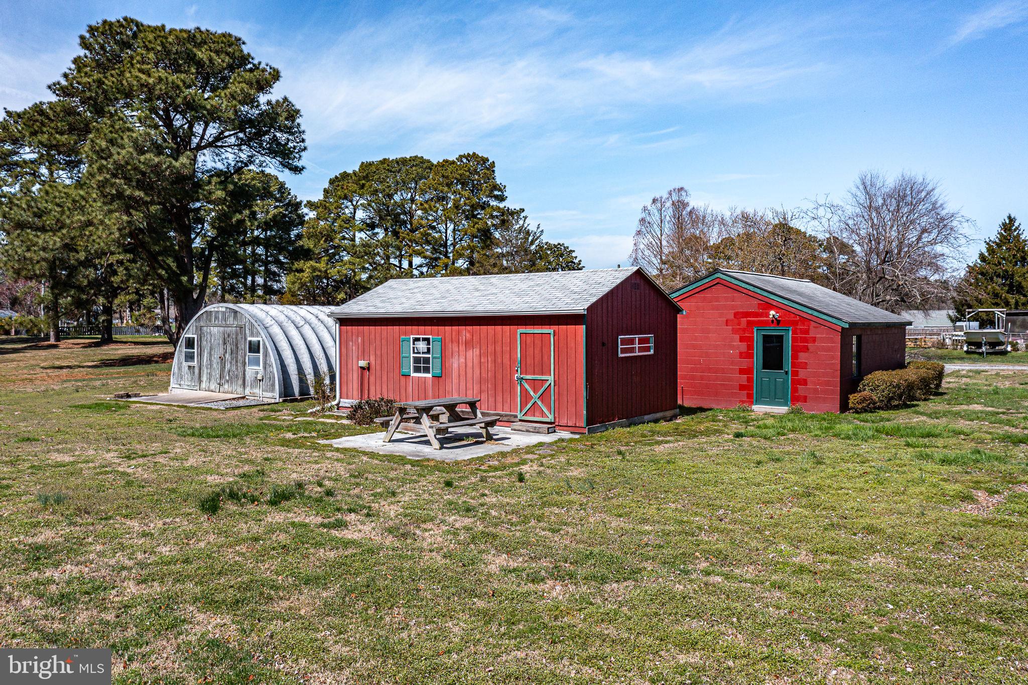 305 Colieville Lane Reedville, VA 22539 - Photo 40 of 49 Charming outbuildings in serene landscape.