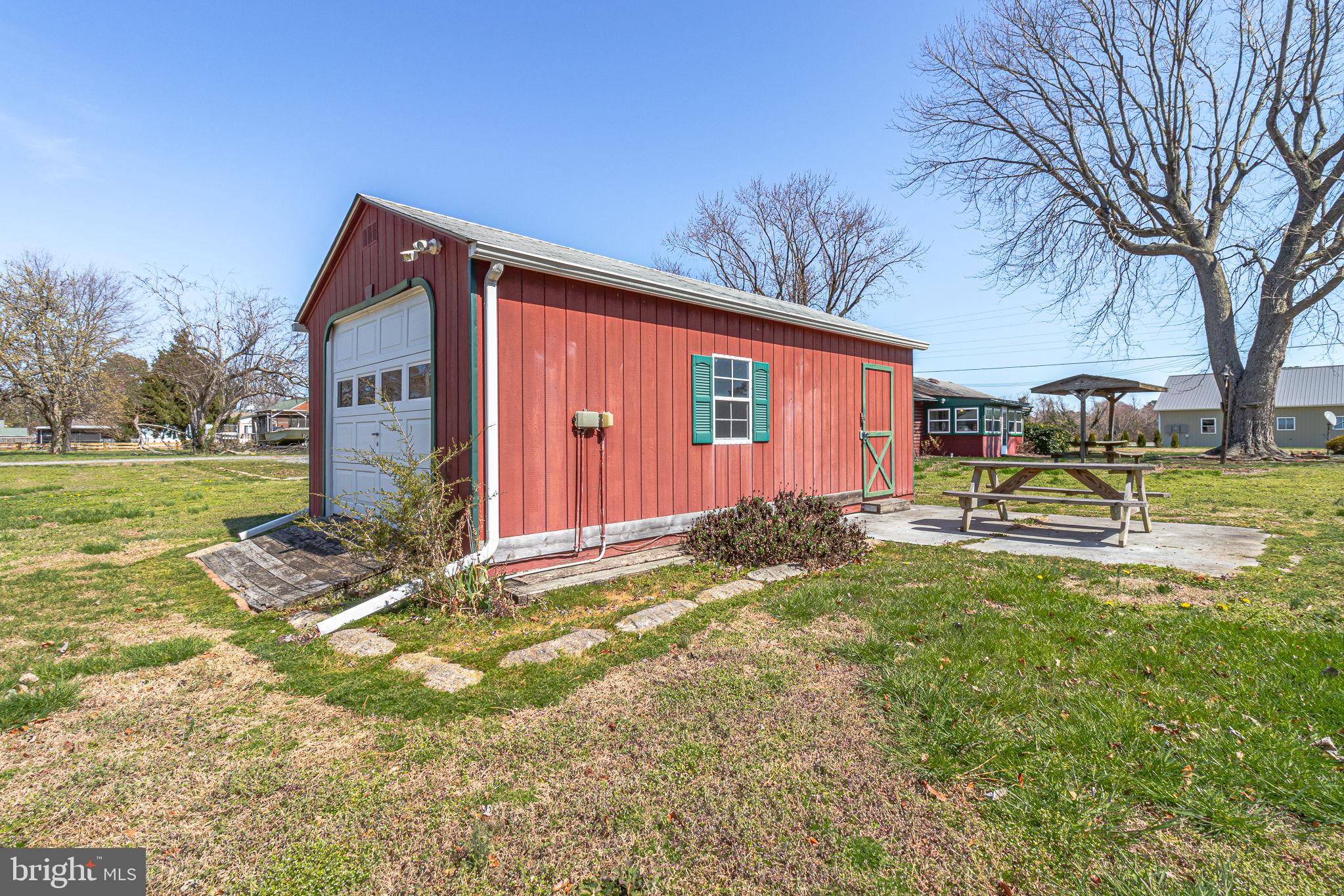 305 Colieville Lane Reedville, VA 22539 - Photo 44 of 49 Charming red shed in open green space.