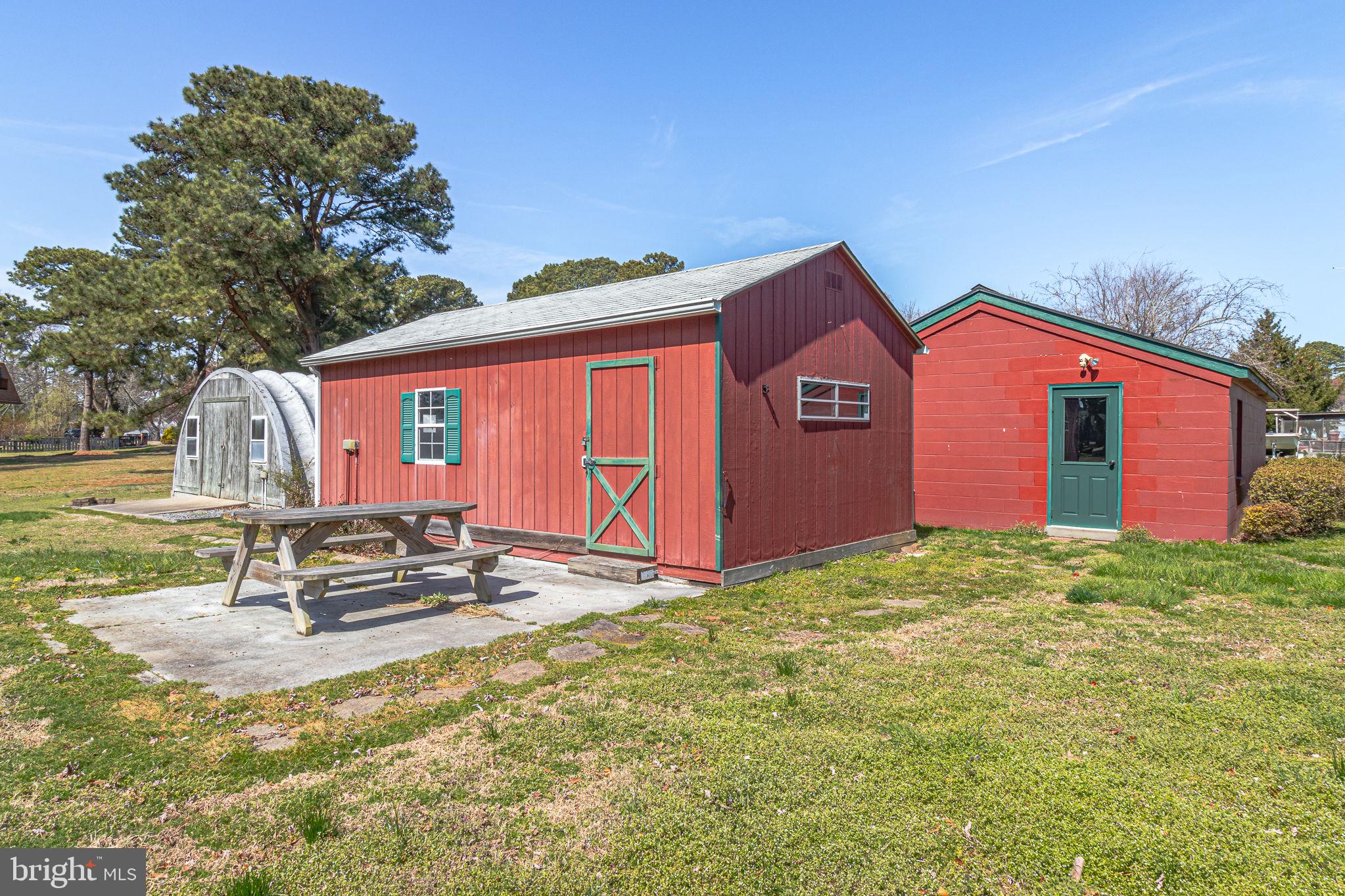 305 Colieville Lane Reedville, VA 22539 - Photo 45 of 49 Charming red outbuildings in nature.