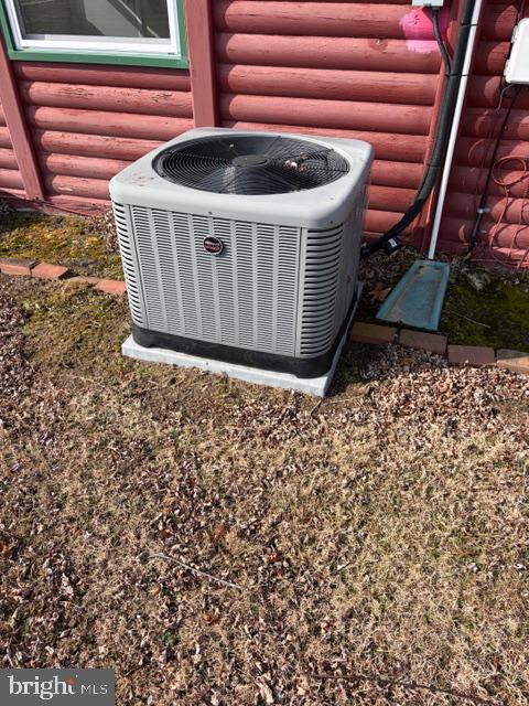 305 Colieville Lane Reedville, VA 22539 - Photo 48 of 49 Cooling unit by rustic log home.